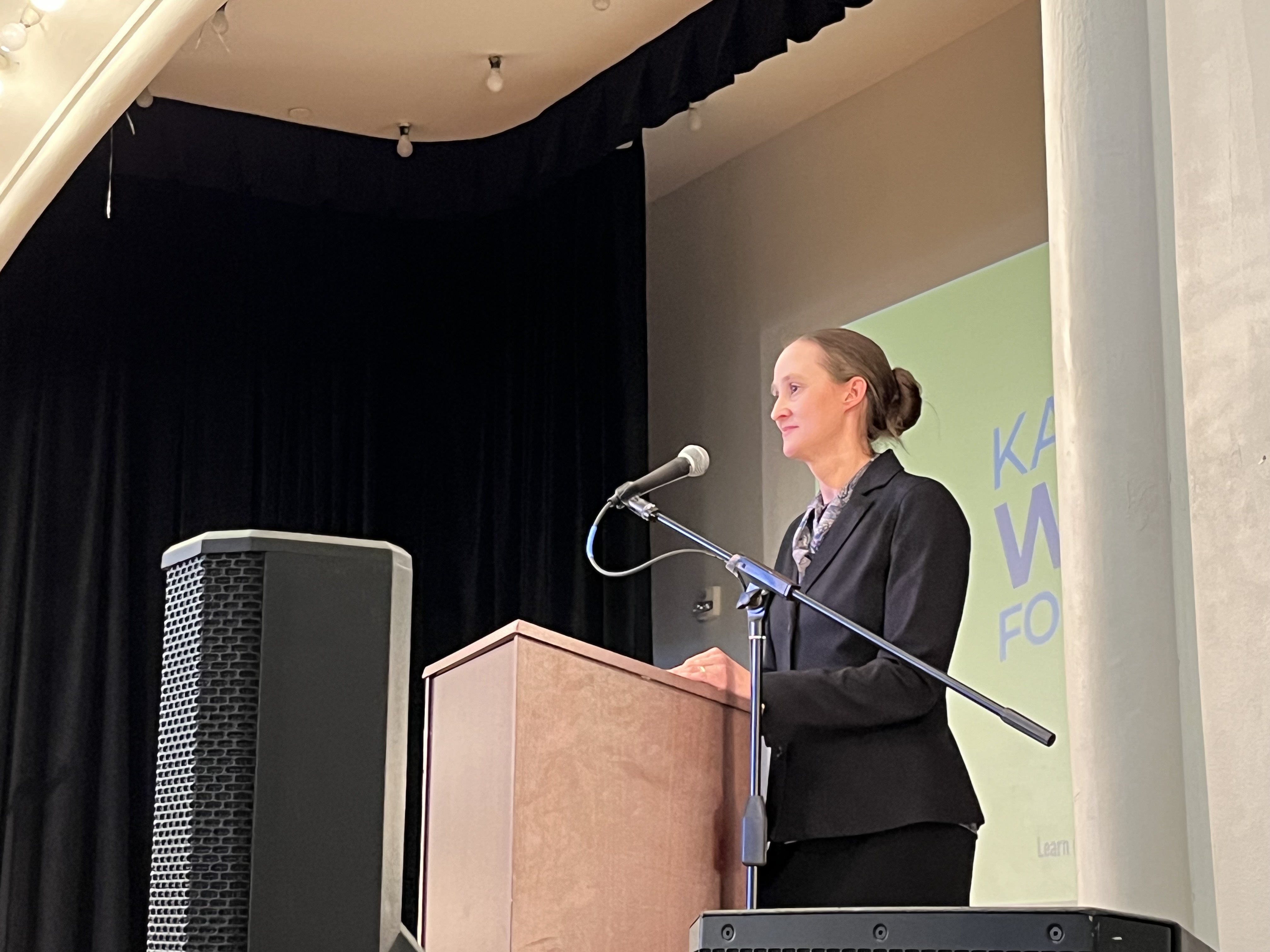 caption: Katie Wilson speaks at a campaign rally in her race for mayor at Washington Hall on Oct. 26, 2025. 