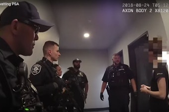 caption: Seattle police officers talk to a victim of "swatting" -- a hoax 911 call.