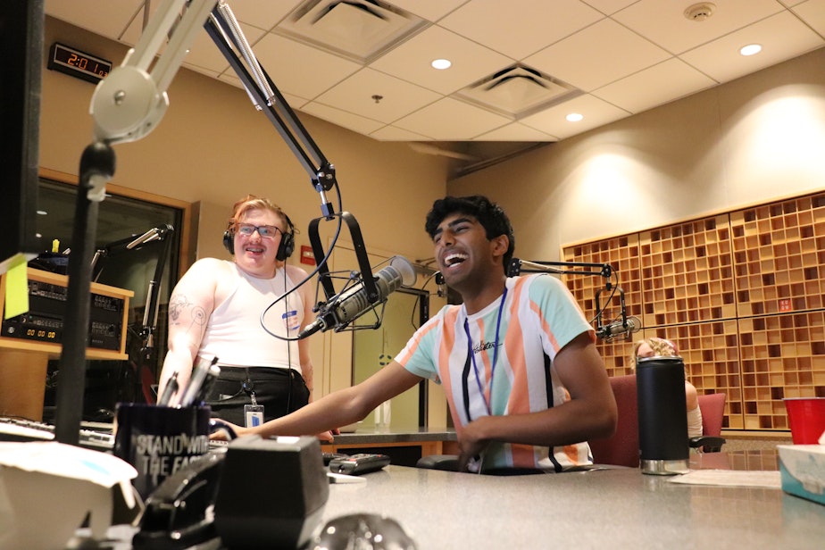 caption: Sidh Shroff and RadioActive peer mentor Lucas Galarneau record in a KUOW studio on July 12, 2023.