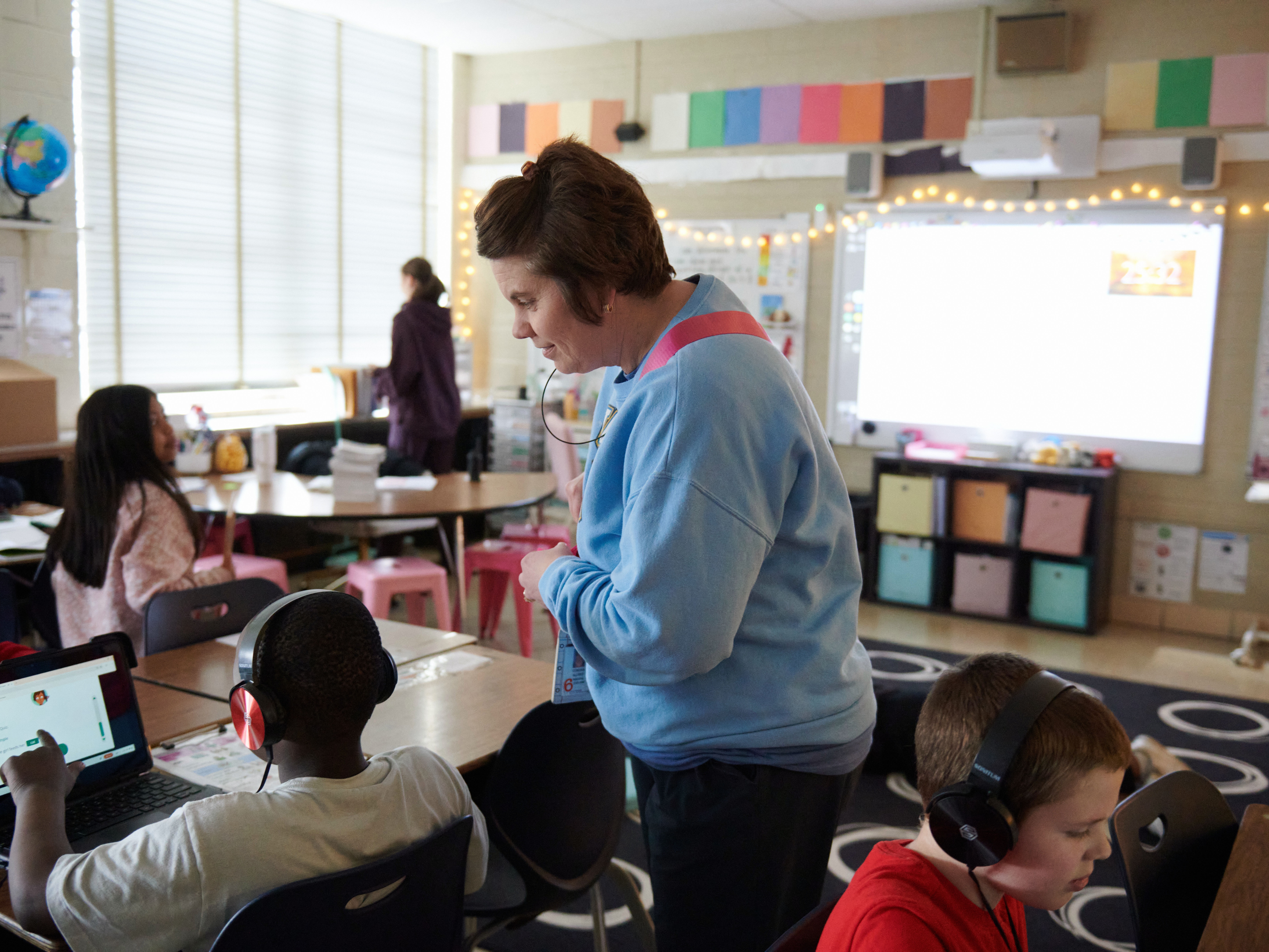 caption: Principal Condra Allred visits a third grade class at Cleveland Elementary School in Cedar Rapids, Iowa, in April. Soon, Allred expects to hear for certain if her school will close.