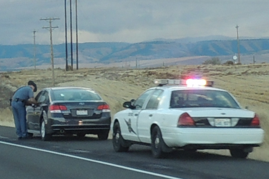 caption: A Washington State Patrol trooper pulls over a car on a highway near Walla Walla, Wash. 