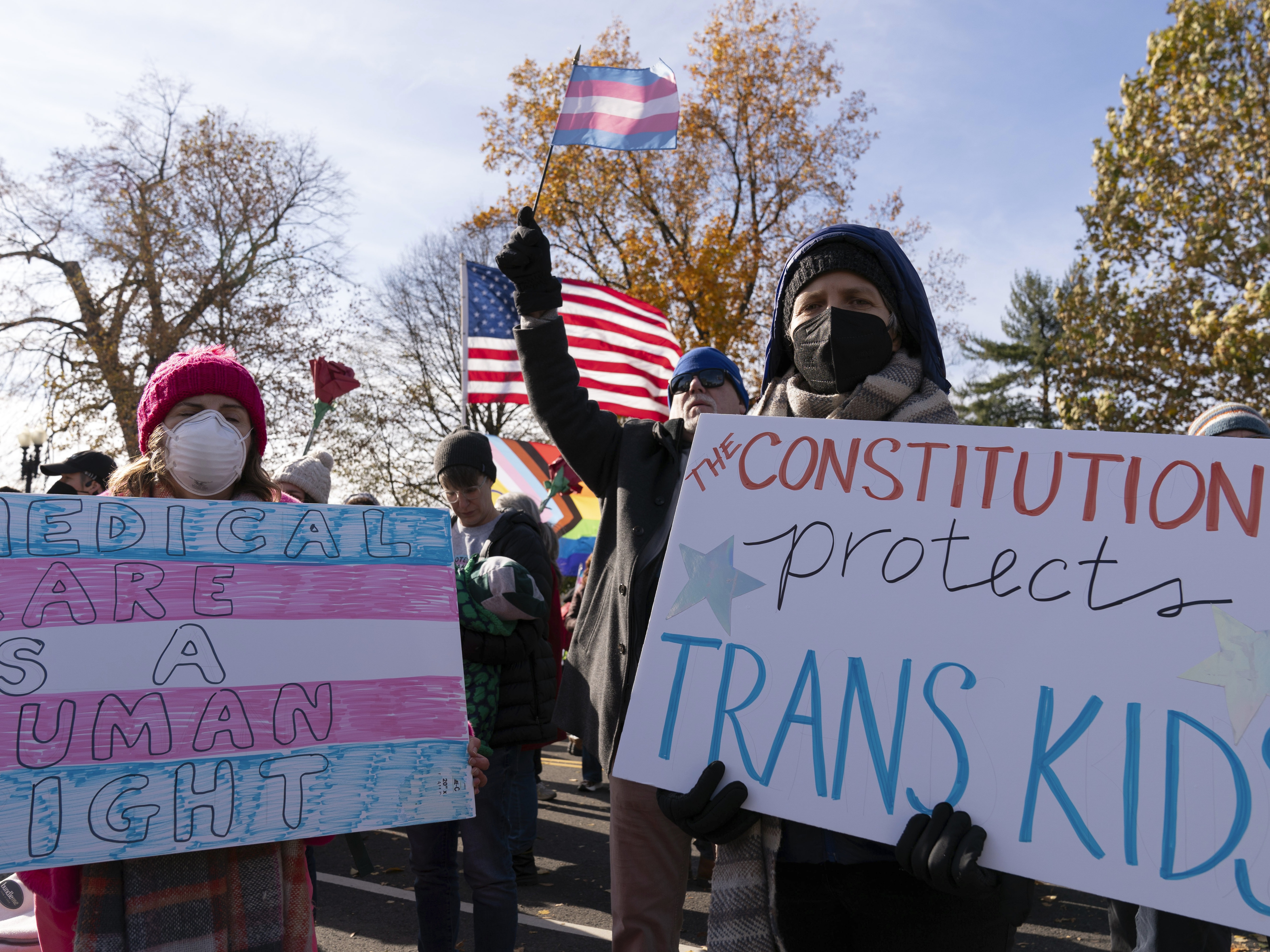 caption: Supporters of transgender rights hold signs as they rally outside the Supreme Court on Wednesday in Washington, D.C., as arguments begin in a case regarding a Tennessee law banning gender-affirming medical care for transgender youth.