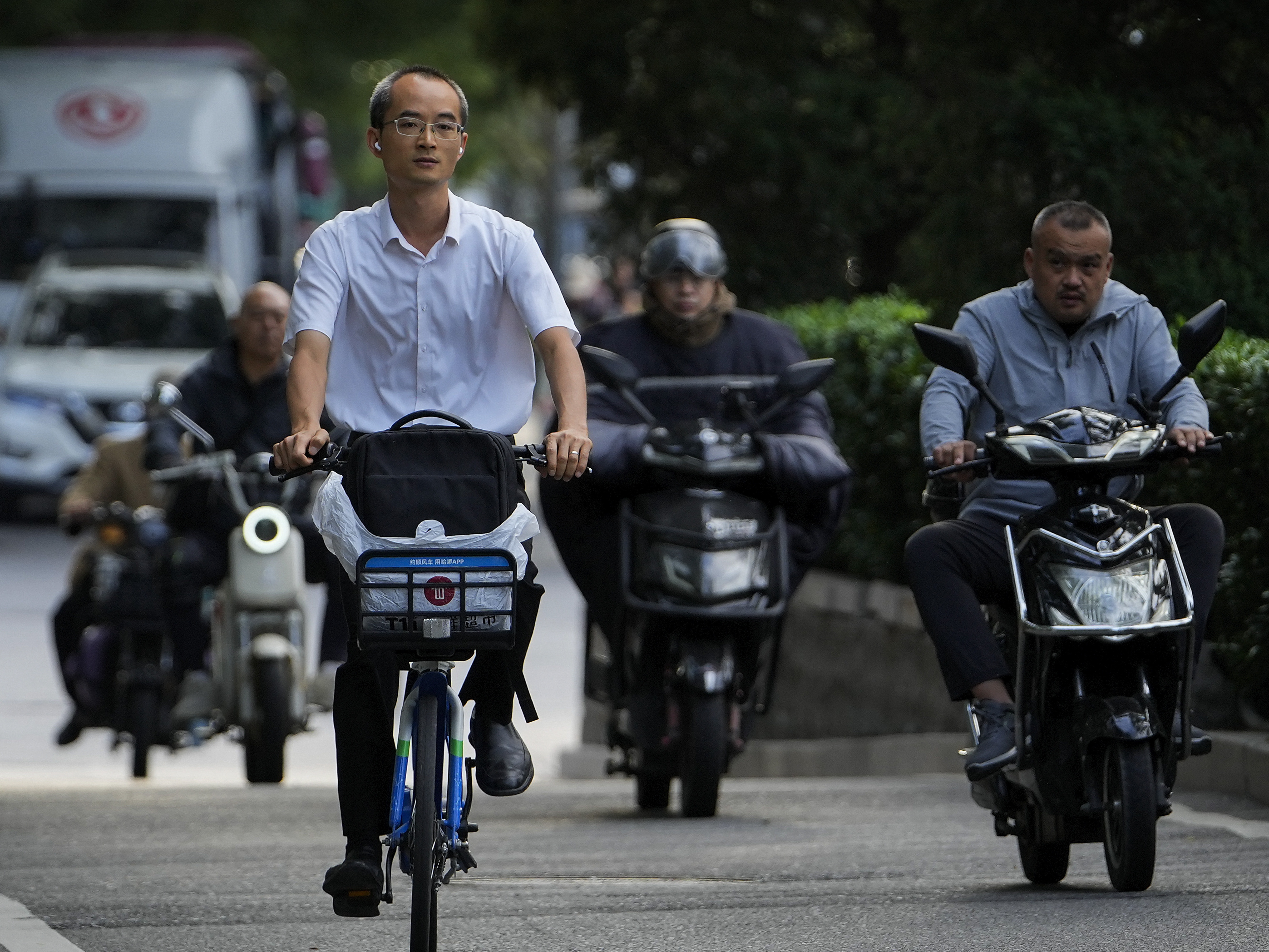 caption: Motorists drive during the morning rush hour in Beijing on Friday.