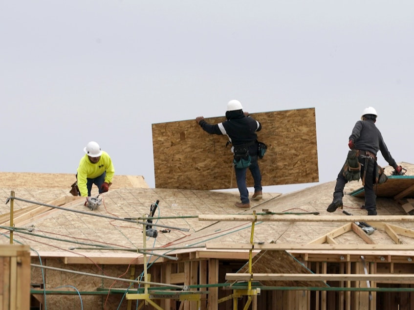 caption: Home builders at work in Sacramento, Calif. Democrats in Congress are trying to pass a bill that would make the largest investment in affordable housing in history and try to boost construction of more moderately priced homes.