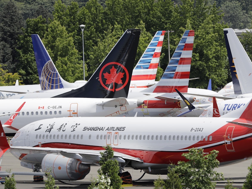 caption: Grounded Boeing 737 Max airplanes crowd a parking area in Seattle in June, 2019.