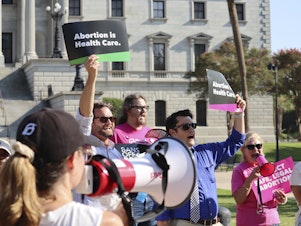 caption: Over two dozen abortion-rights supporters attend a rally outside the South Carolina State House in Columbia, S.C., on Aug. 23, 2023. The South Carolina Supreme Court ruled to uphold a law banning most abortions except those in the earliest weeks of pregnancy.