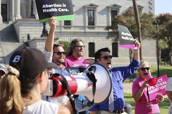 caption: Over two dozen abortion-rights supporters attend a rally outside the South Carolina State House in Columbia, S.C., on Aug. 23, 2023. The South Carolina Supreme Court ruled to uphold a law banning most abortions except those in the earliest weeks of pregnancy.