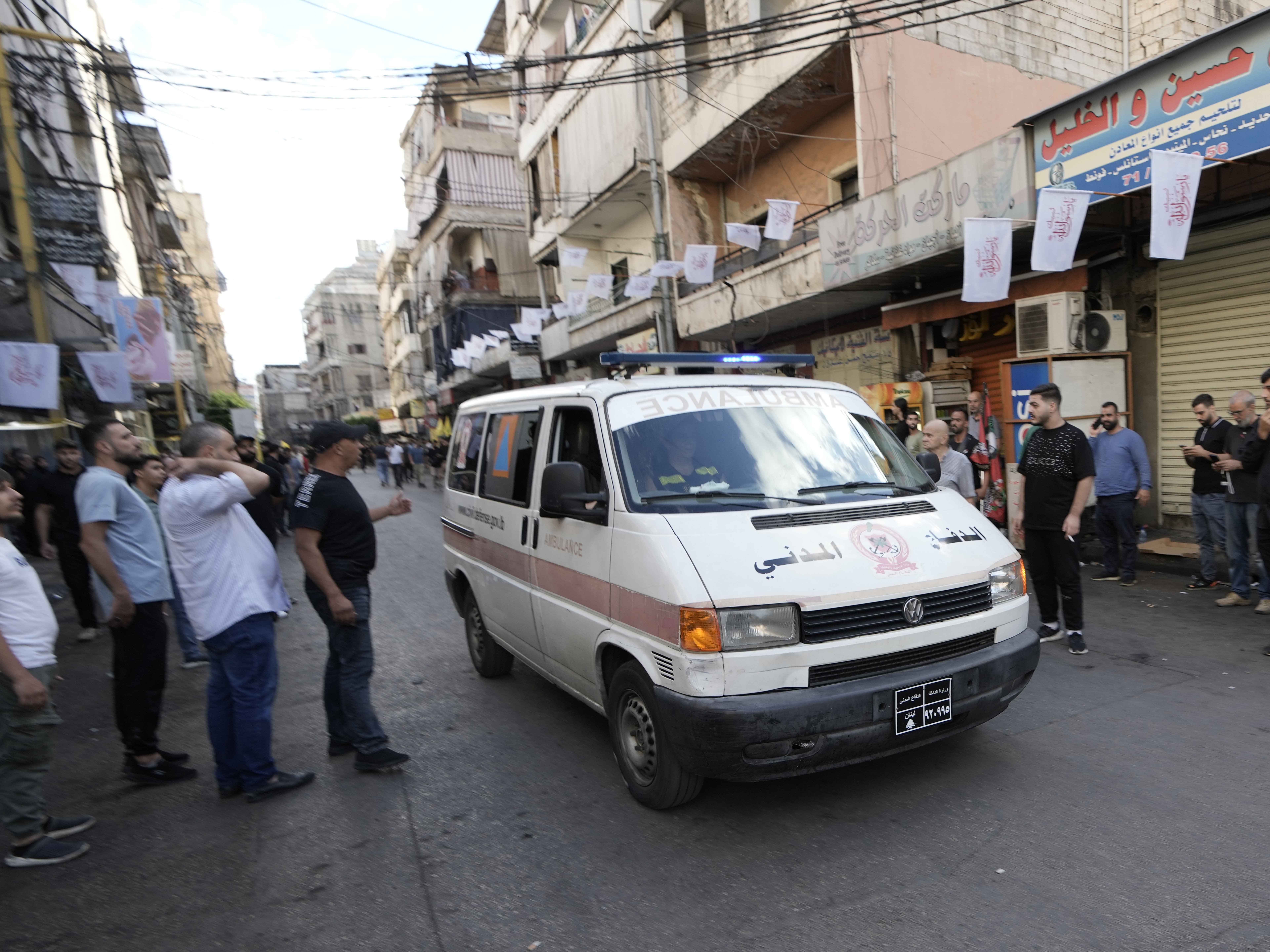 caption: An ambulance believed to be carrying wounded people — after multiple explosions were heard during the funeral of four Hezbollah fighters who were killed Tuesday after their pagers exploded — drives down a street in a southern suburb of Beirut on Wednesday.