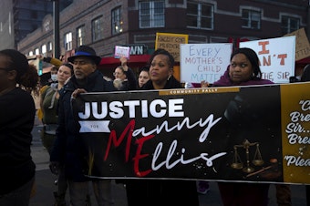 caption: Candace Wesley, center, joins family, friends and supporters for a rally in honor of Manuel Ellis following a verdict of not guilty for the three Tacoma police officers involved in the death of Ellis, on Thursday, December 21, 2023, in Tacoma. 