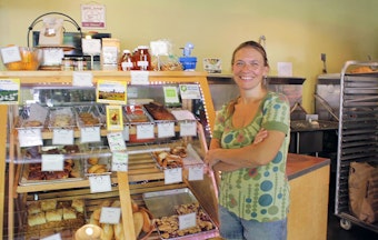 caption: Annette Heide-Jessen's Kaffeeklatsch coffee shop has bet on Lake City Way. A big garage door opens right onto the state highway, which doubles as Lake City's 'main street.' Heide-Jessen sees Lake City as 'the next Columbia City.'