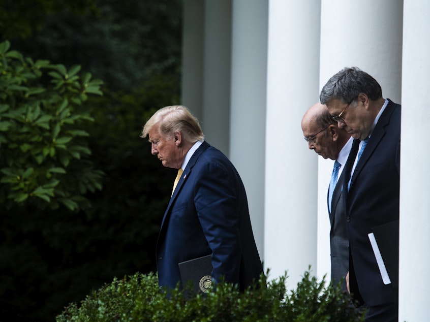caption: President Trump, Commerce Secretary Wilbur Ross (center) and U.S. Attorney General William Barr walk into the White House Rose Garden for a July 2019 press conference on the census.