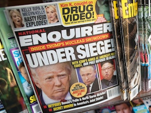 caption: The cover of the National Enquirer in July 2017 featuring President Trump. The tabloid is for sale.