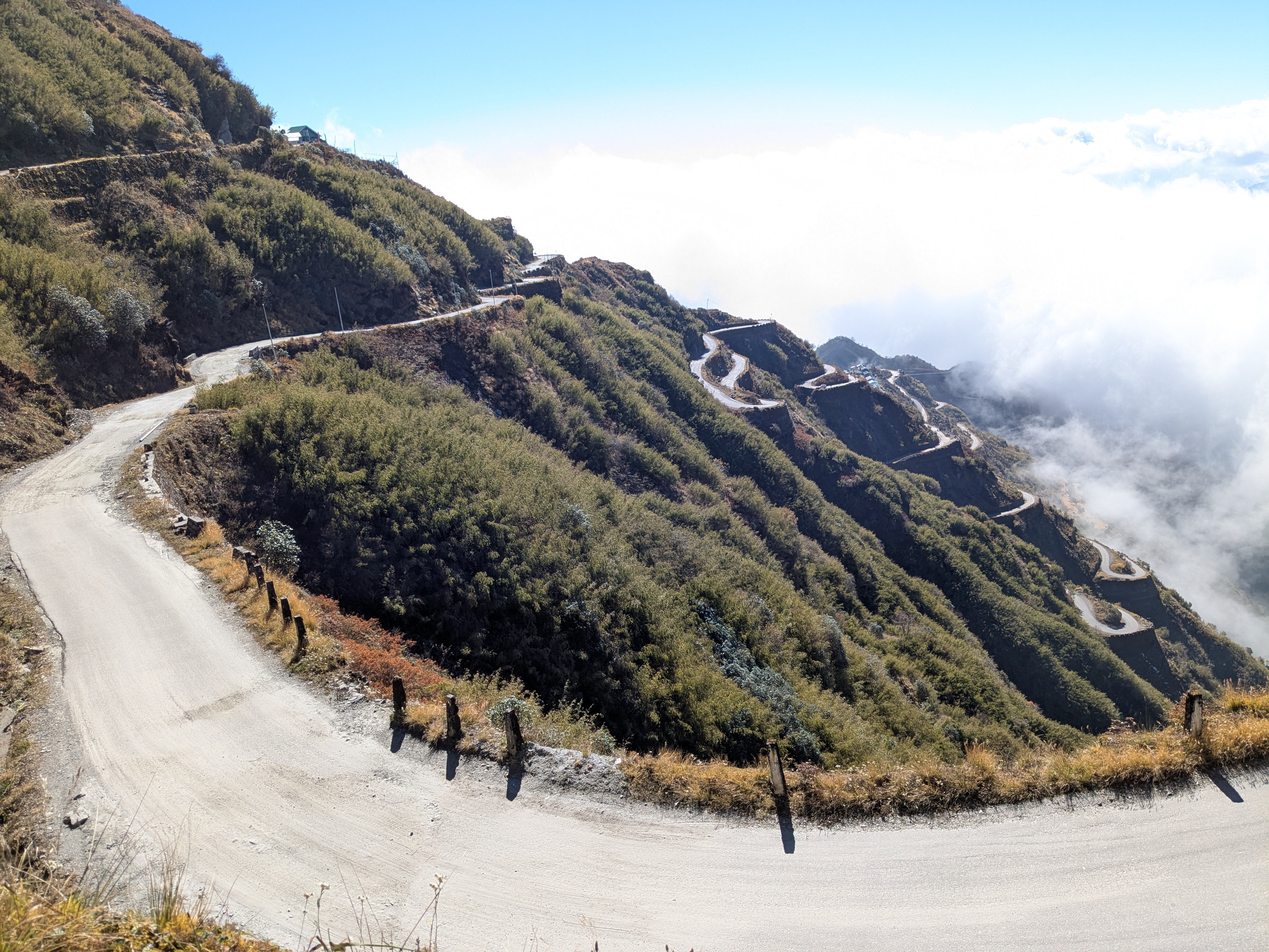 caption: A road curves around the mountains near Zuluk village in the Indian state of Sikkim. In recent years, the Indian government has worked to boost road connectivity in such villages near its border with China.