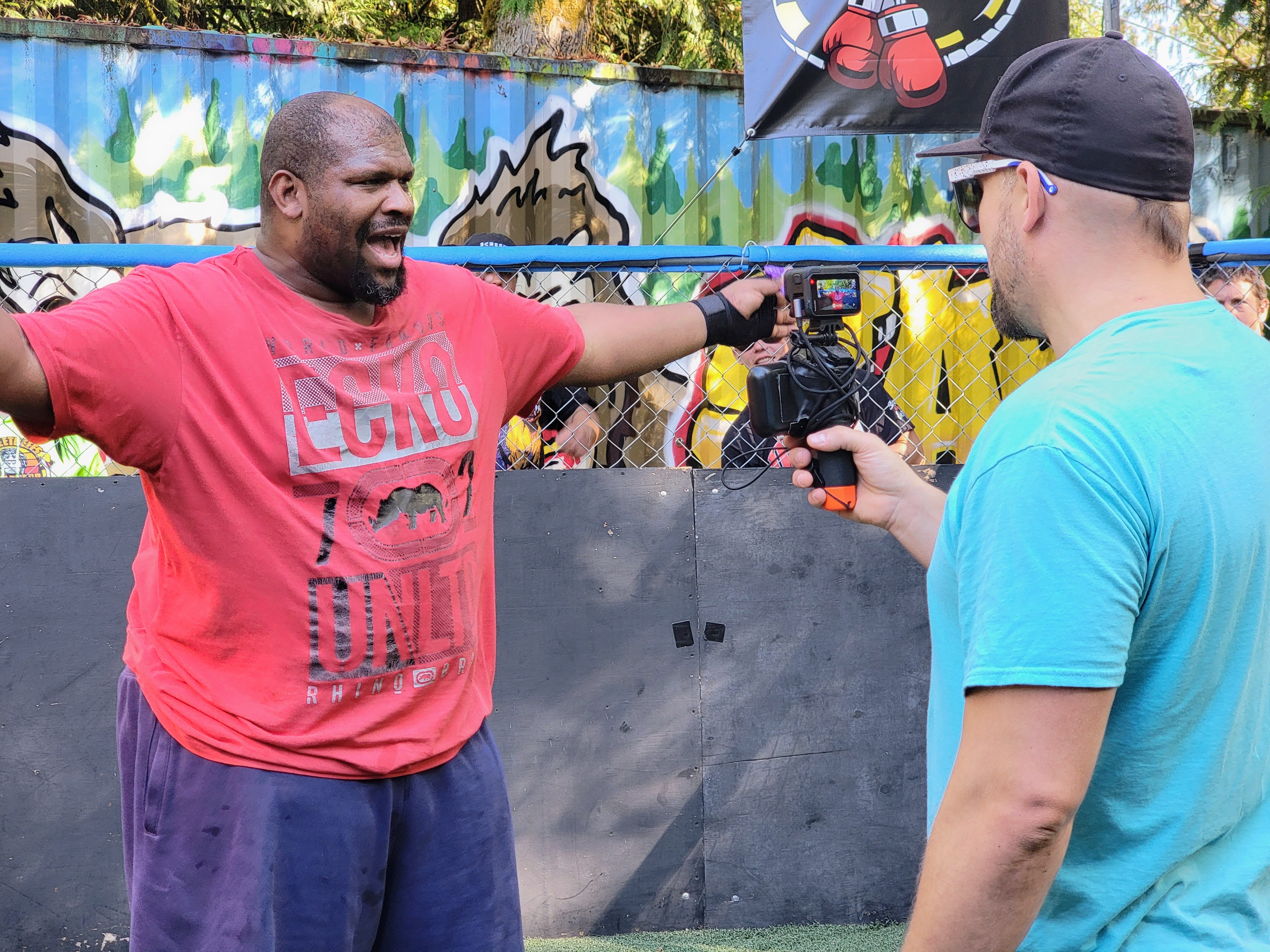 caption: Steve "Firechicken" Hagara (right) hosts and films all of the fights at the Scrapyard on Saturday, Sept. 20, 2025.