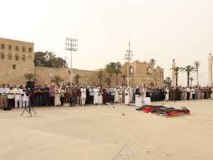 caption: Mourners gather for funeral prayers for fighters killed by warplanes of Khalifa Haftar's forces on April 24 in Tripoli, Libya.