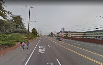 caption: A section of state Route 99 near Evergreen Washelli Funeral Home that does not have sidewalks, but does have pedestrians.