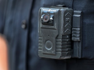 caption: Police officer David Moore is pictured wearing a body camera in Ipswich, Mass., on Dec. 1, 2020. The city was among 25 statewide awarded grants to purchase body-worn cameras for videotaping interactions with the public. A new study says the benefits to society and police departments outweigh the costs of the cameras.