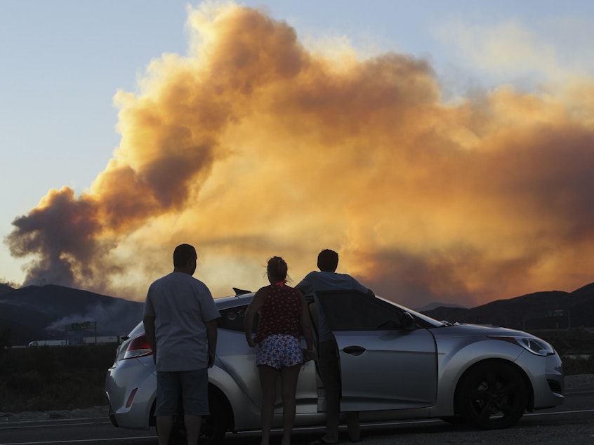 caption: People watch the Blue Cut Fire in Lytle Creek, Calif., in 2016.