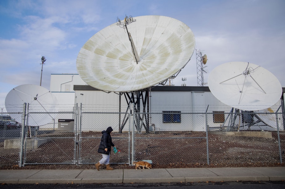 caption: Michelle Aguilar Ramirez walks her dog Bruce in her Spokane, Washington, neighborhood.