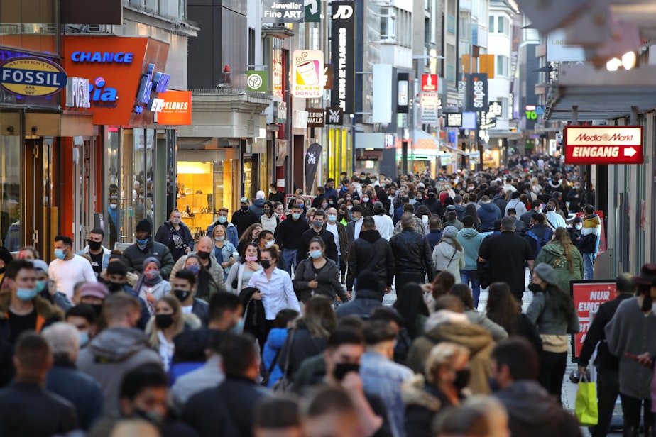 caption: People wear protective face masks on the third day that local authorities mandated anew the wearing of masks outside in the city center during the second wave of the coronavirus pandemic on October 31, 2020 in Cologne, Germany. (Andreas Rentz/Getty Images)