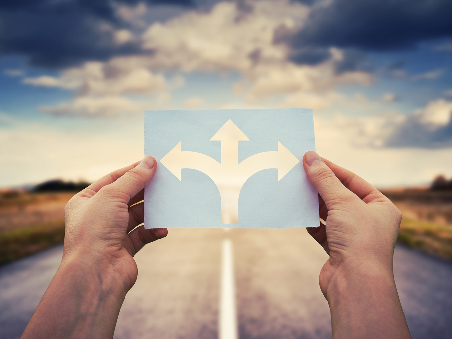 Hands,Holding,Paper,With,Arrows,Crossroad,Symbol,Splitted,In,Three