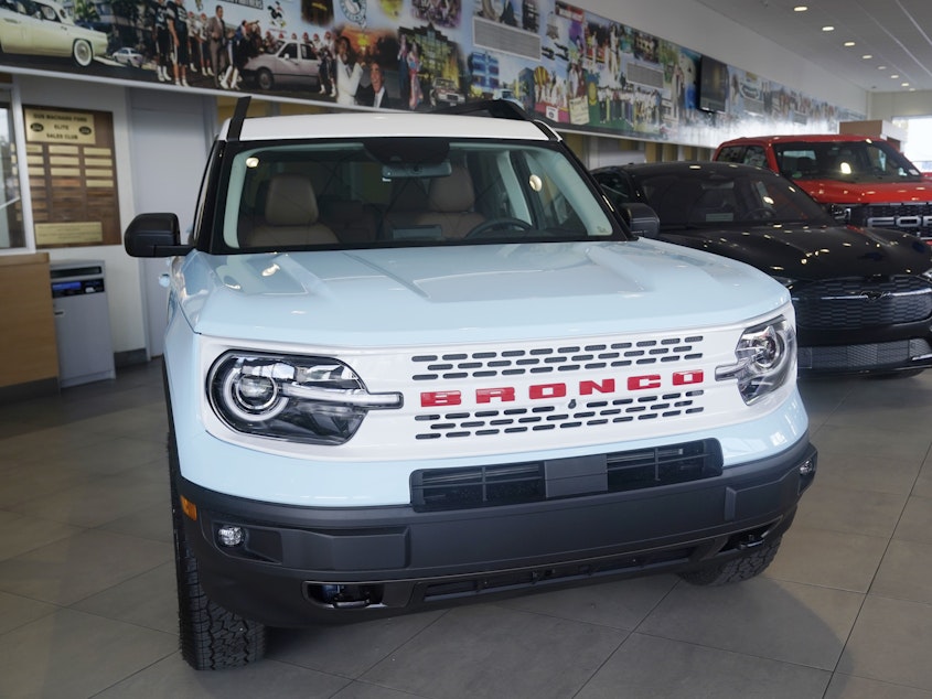 caption: A Ford Bronco is displayed at a Ford dealership in Hialeah, Fla., on Jan. 23, 2023. Ford is recalling more than 456,000 Bronco Sport and Maverick vehicles due to a battery detection issue that can result in loss of drive power.