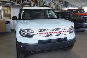 caption: A Ford Bronco is displayed at a Ford dealership in Hialeah, Fla., on Jan. 23, 2023. Ford is recalling more than 456,000 Bronco Sport and Maverick vehicles due to a battery detection issue that can result in loss of drive power.