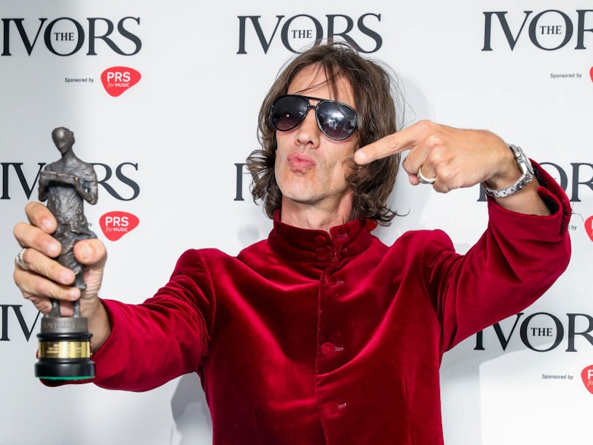 caption: Richard Ashcroft, frontman of The Verve, poses with his Ivor Novello Award on Wednesday in London. A songwriting dispute had left the Britpop band bereft of royalties from its biggest hit, "Bitter Sweet Symphony." More than 20 years later, the Rolling Stones' Mick Jagger and Keith Richards have signed over their rights.