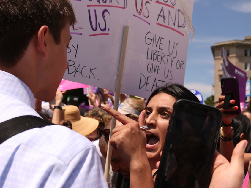 caption: A pro-abortion rights supporter argues with an anti-abortion rights protester in front of the U.S. Supreme Court May 21 during demonstrations in defense of abortion rights.