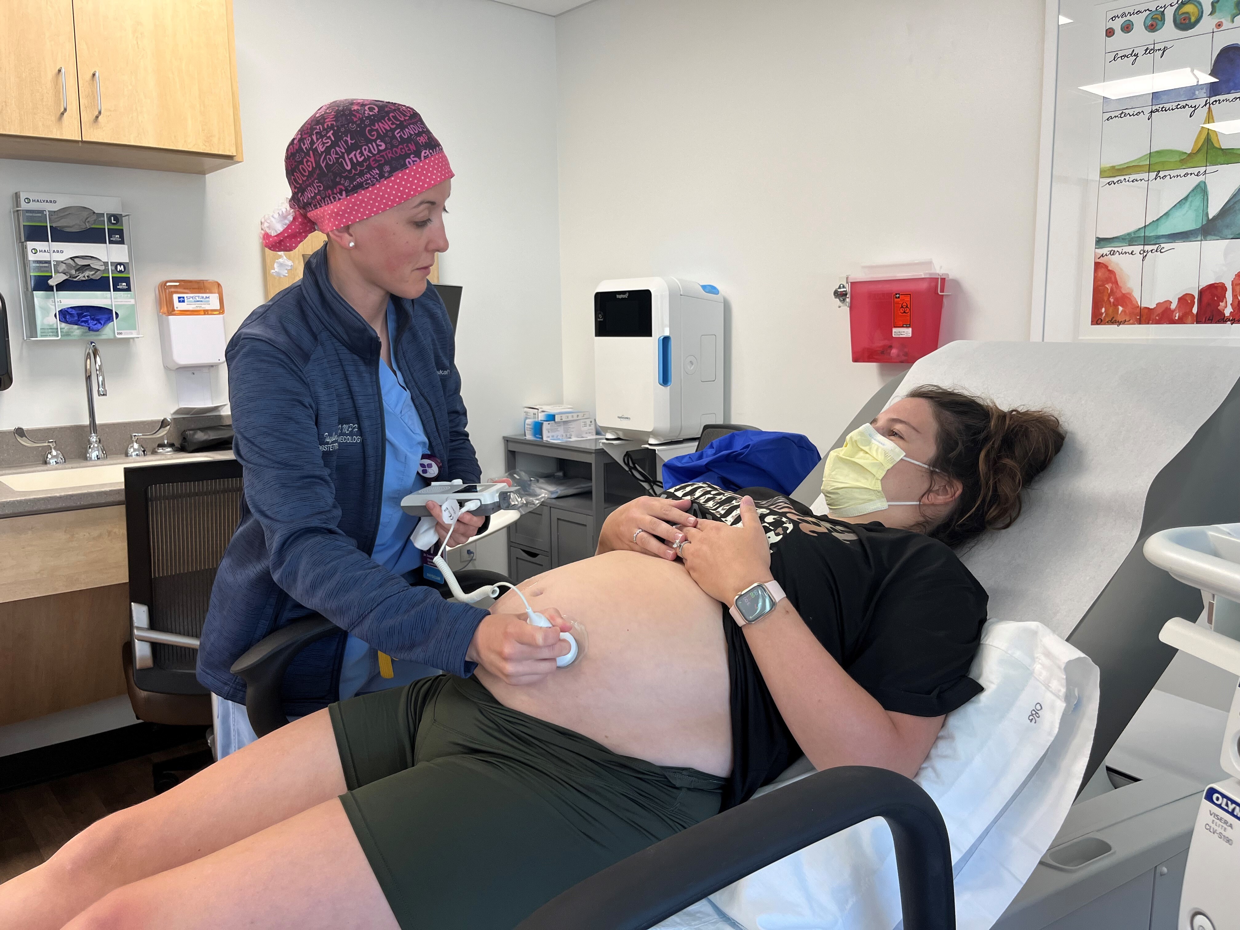 caption: Obstetrician-gynecologist Taylar Swartz uses an ultrasound scanner to check the health of Addie Comegys' baby on May 30. Comegys, who is due in late August, had traveled 45 minutes for her prenatal appointment at Mahaska Health in Oskaloosa, one of a few rural hospitals in Iowa still offering labor and delivery services.