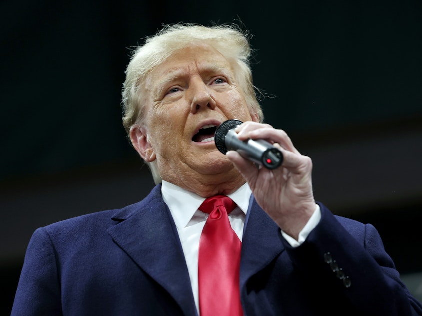 caption: Former president Donald Trump speaks to voters during a visit to a caucus site at the Horizon Event Center on January 15, 2024 in Clive, Iowa.