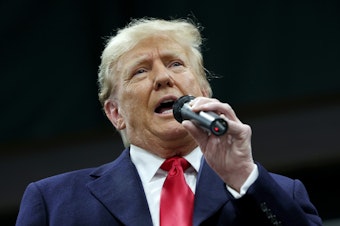 caption: Former president Donald Trump speaks to voters during a visit to a caucus site at the Horizon Event Center on January 15, 2024 in Clive, Iowa.