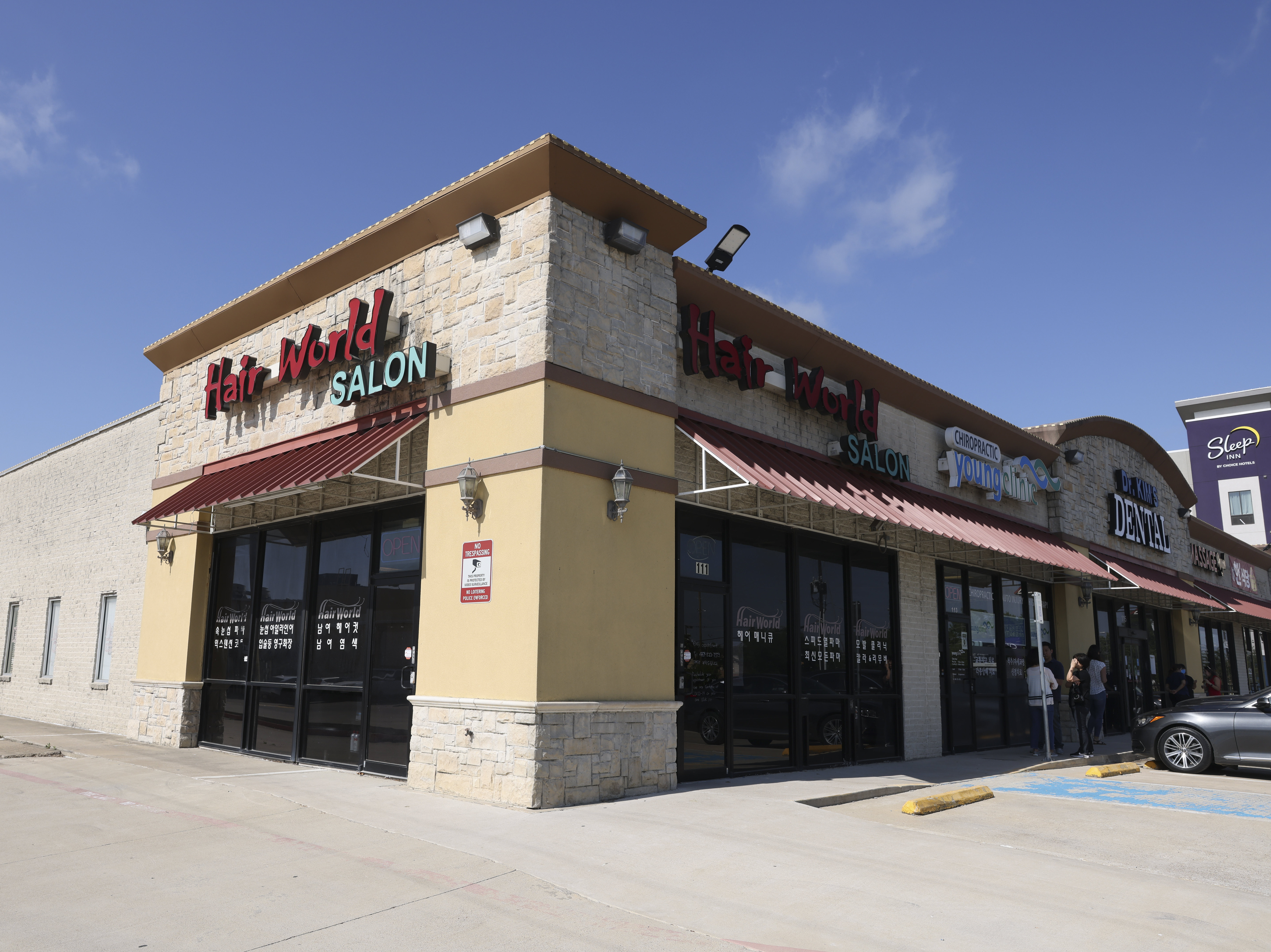 caption: Authorities have said a man dressed all in black opened fire at the Hair World Salon on Wednesday, wounding three women, then drove off in a maroon minivan. A suspect has been arrested in the shooting, police said Tuesday.