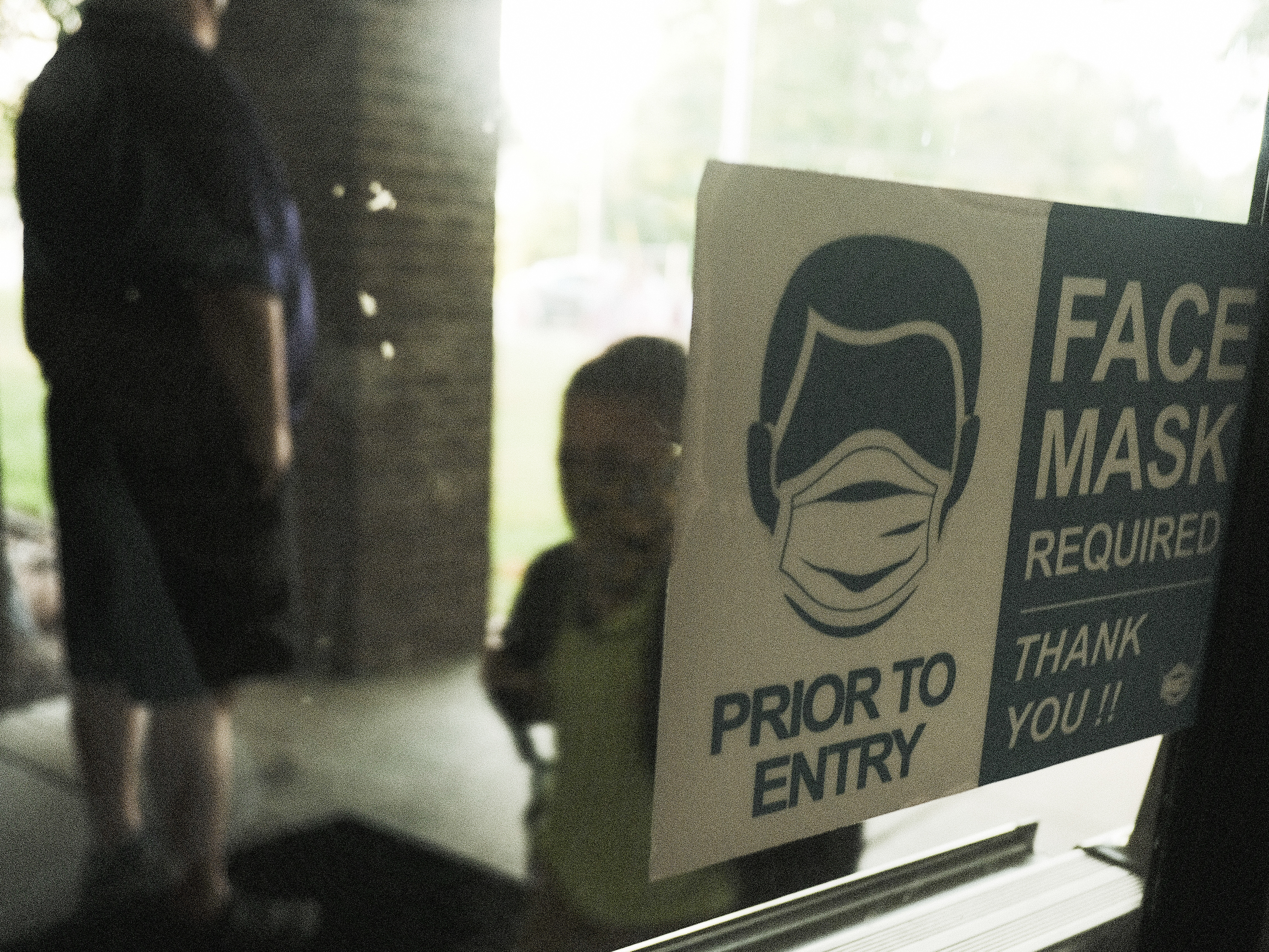 caption: In federal lawsuits, parents in Wisconsin are blaming school districts for COVID-19 infections, saying they should not have ended mask requirements during a pandemic. Here, a student in Michigan is seen arriving at school in late August.