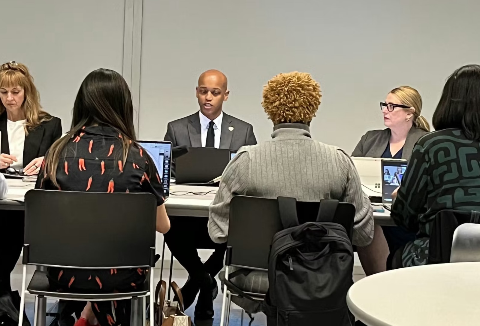 caption: King County Executive Girmay Zahilay, center, and KCRHA CEO Kelly Kinnison, right, at the April 24, 2026 board meeting discussing a new forensic audit. 