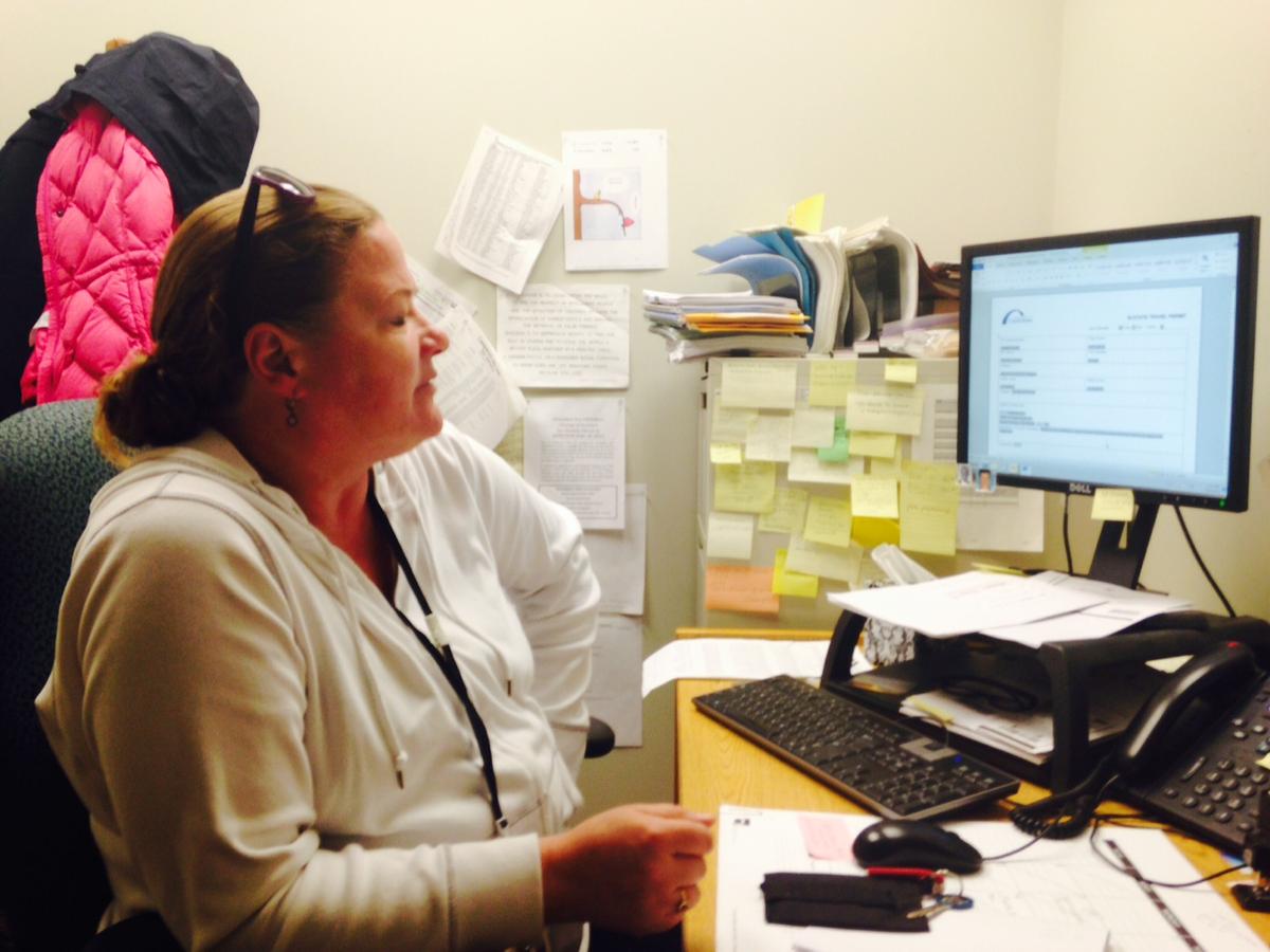caption: Community Corrections Officer Iris Peterson at her desk.