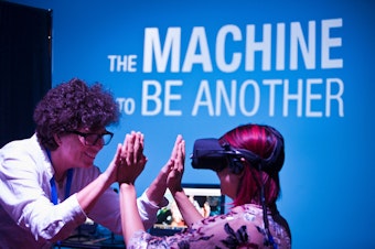 caption: Sandy Cioffi in training with "The Machine To Be Another," part of the Creative Exchange Lab pilot at Pacific Science Center in July 2018. 