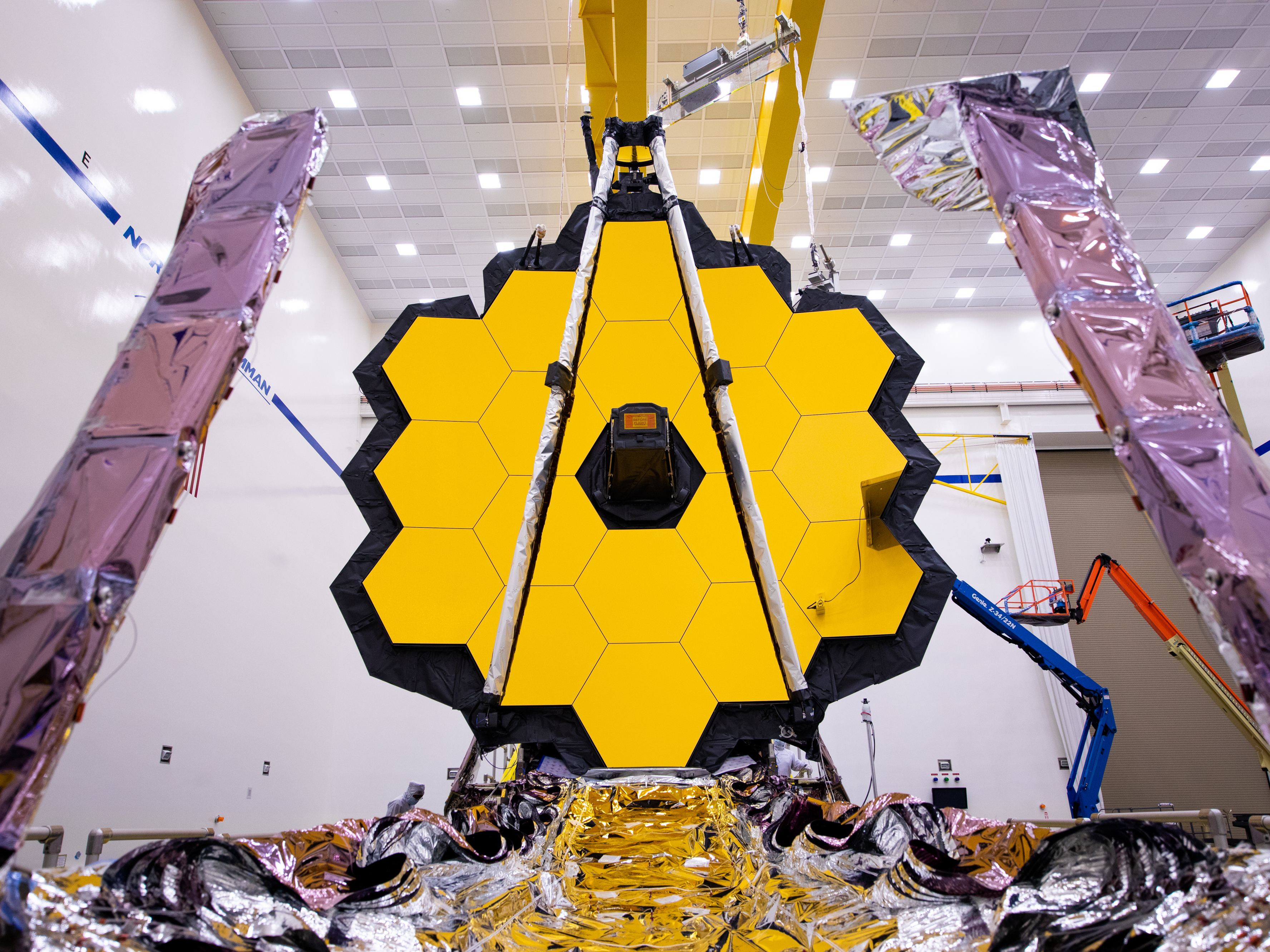 caption: The James Webb Space Telescope (shown here being tested on earth) is expected to reveal some of the most spectacular views of the Universe ever seen.