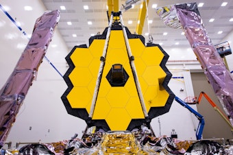 caption: The James Webb Space Telescope (shown here being tested on earth) is expected to reveal some of the most spectacular views of the Universe ever seen.