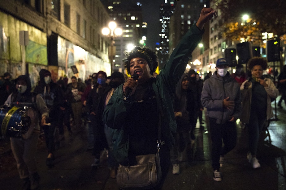 caption: Trae, an organizer with Black Action Coalition, leads a chant as hundreds march through Pioneer Square on Wednesday, November 4, 2020, in Seattle. "We are on stolen land, built with stolen labor by people who look like me," said Trae, earlier in the evening. "When we're saying free all protesters, we need to remember all of our brothers and sisters that are in ICE detention center in Tacoma, Washington, right now - and they need to be free."