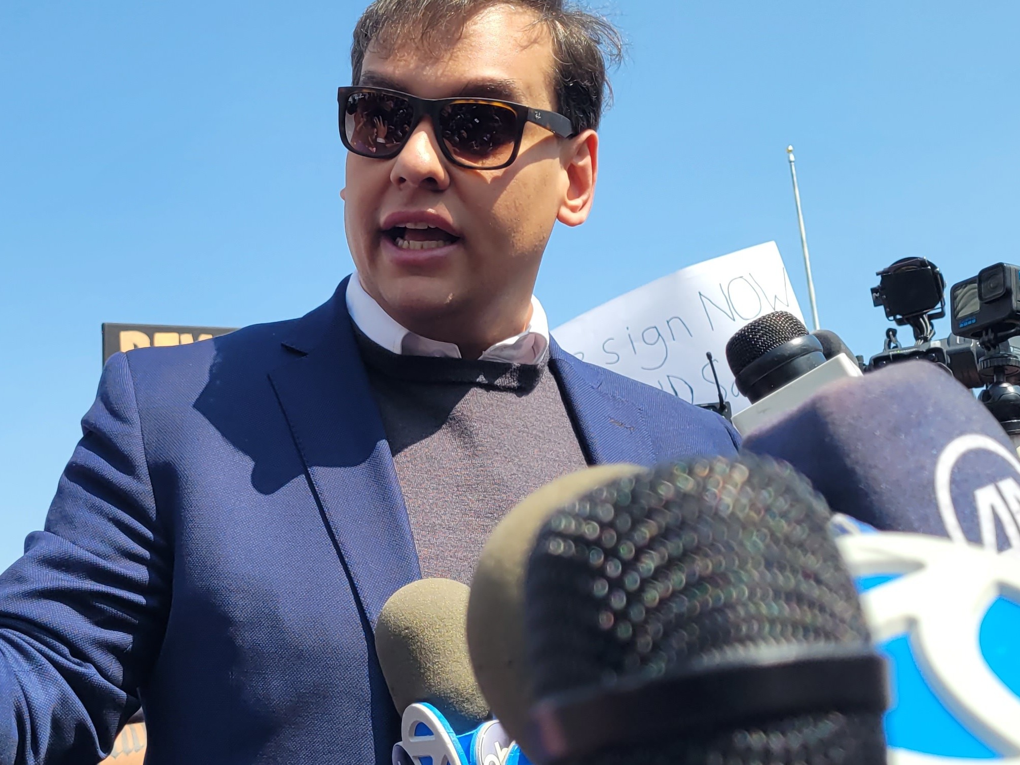 caption: Rep. George Santos (R-NY3) speaking to reporters outside a federal courthouse on Long Island in May after he was charged with 13 federal crimes.