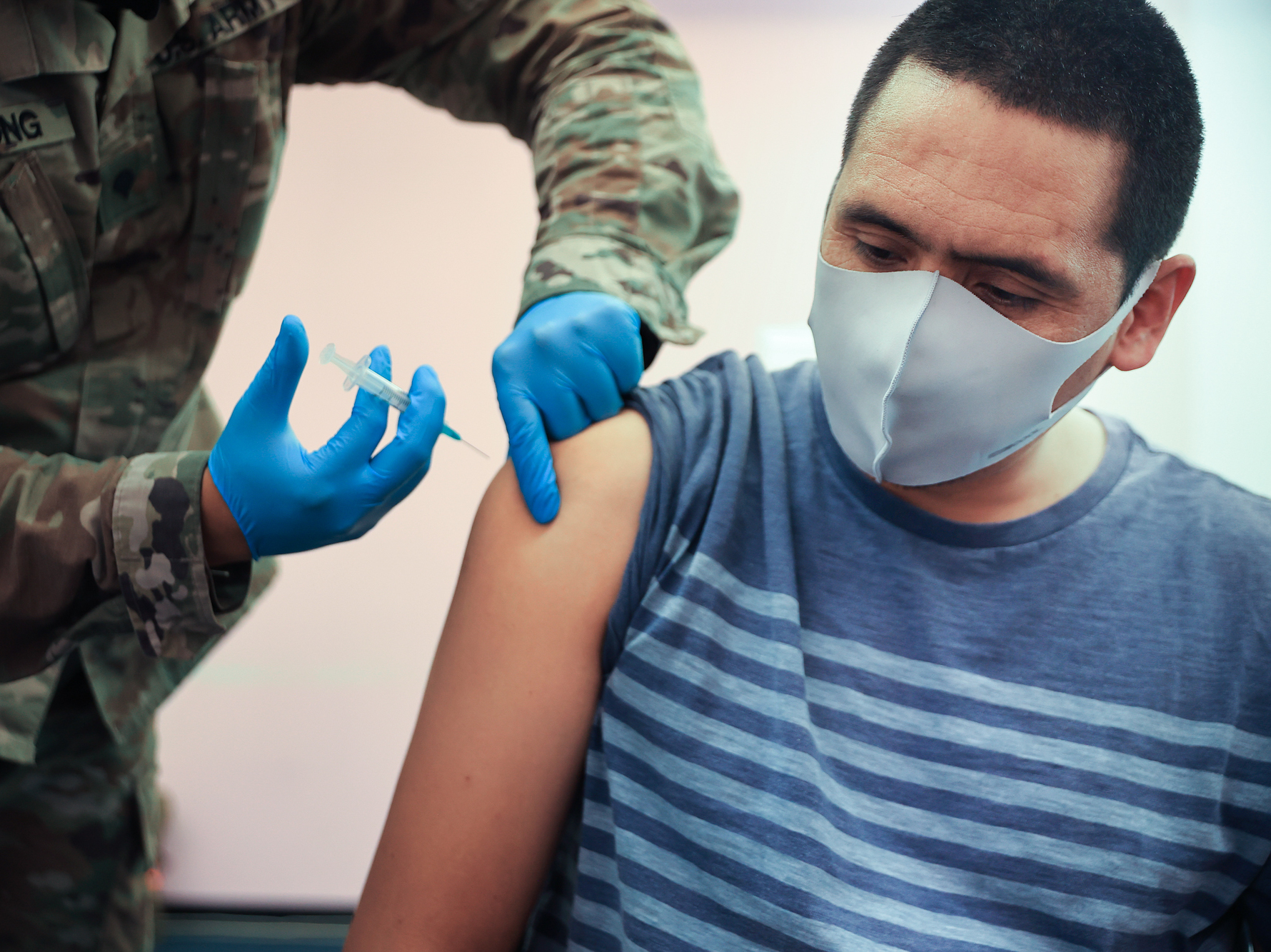 caption: Maryland National Guard Spc. James Truong administers a Moderna COVID-19 vaccine on May 21 in Wheaton, Maryland. People vaccinated with the Moderna vaccine likely need a booster to keep up their protection against the new omicron variant of the coronavirus.