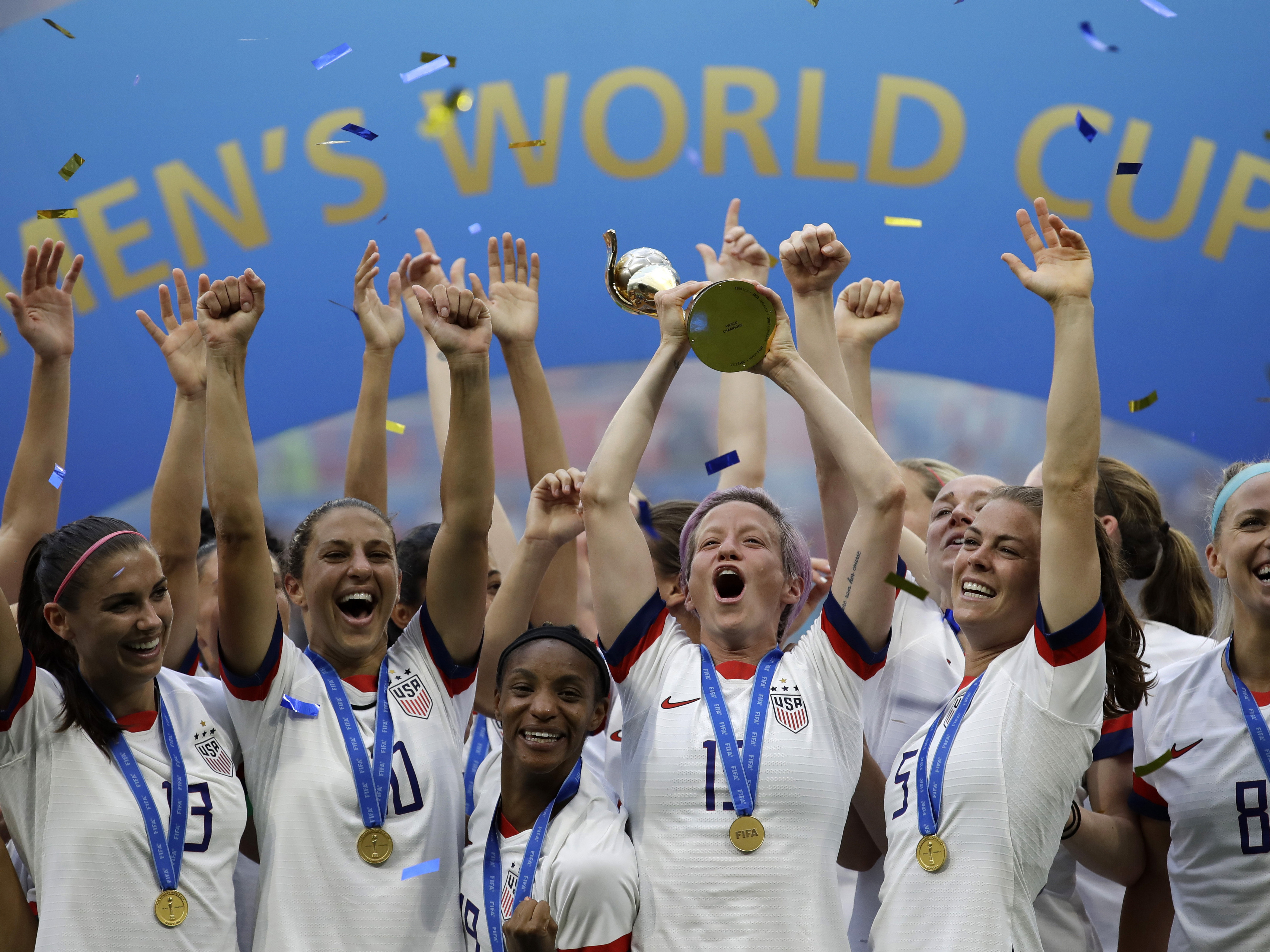 caption: In this July 7, 2019, file photo, United States' Megan Rapinoe lifts up a trophy after winning the Women's World Cup final soccer match between U.S. and The Netherlands at the Stade de Lyon in Decines, outside Lyon, France.
