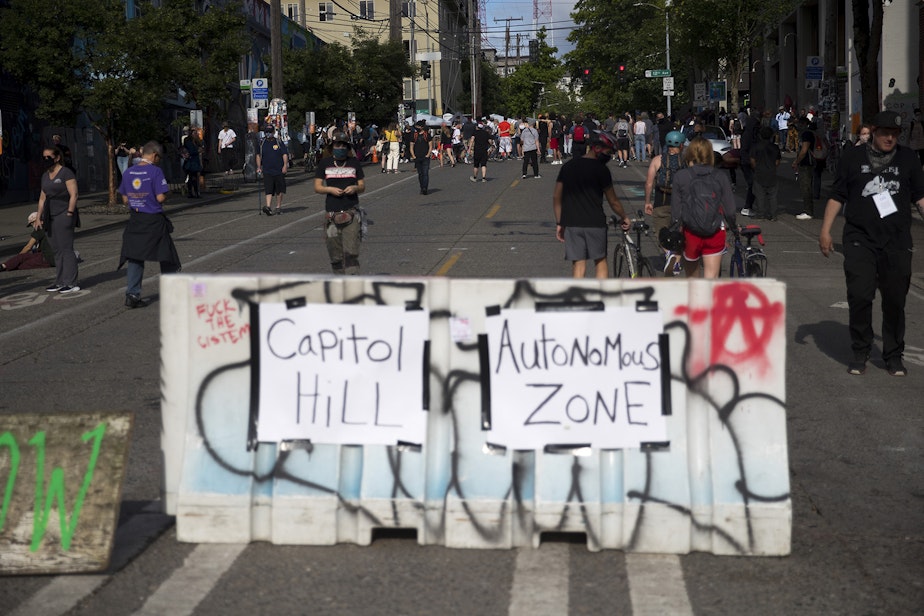 caption: Barriers are set up at the intersection of 11th Avenue and East Pine Street at the 'Capitol Hill Autonomous Zone,' also known as CHAZ, on Wednesday, June 10, 2020, in Seattle. 
