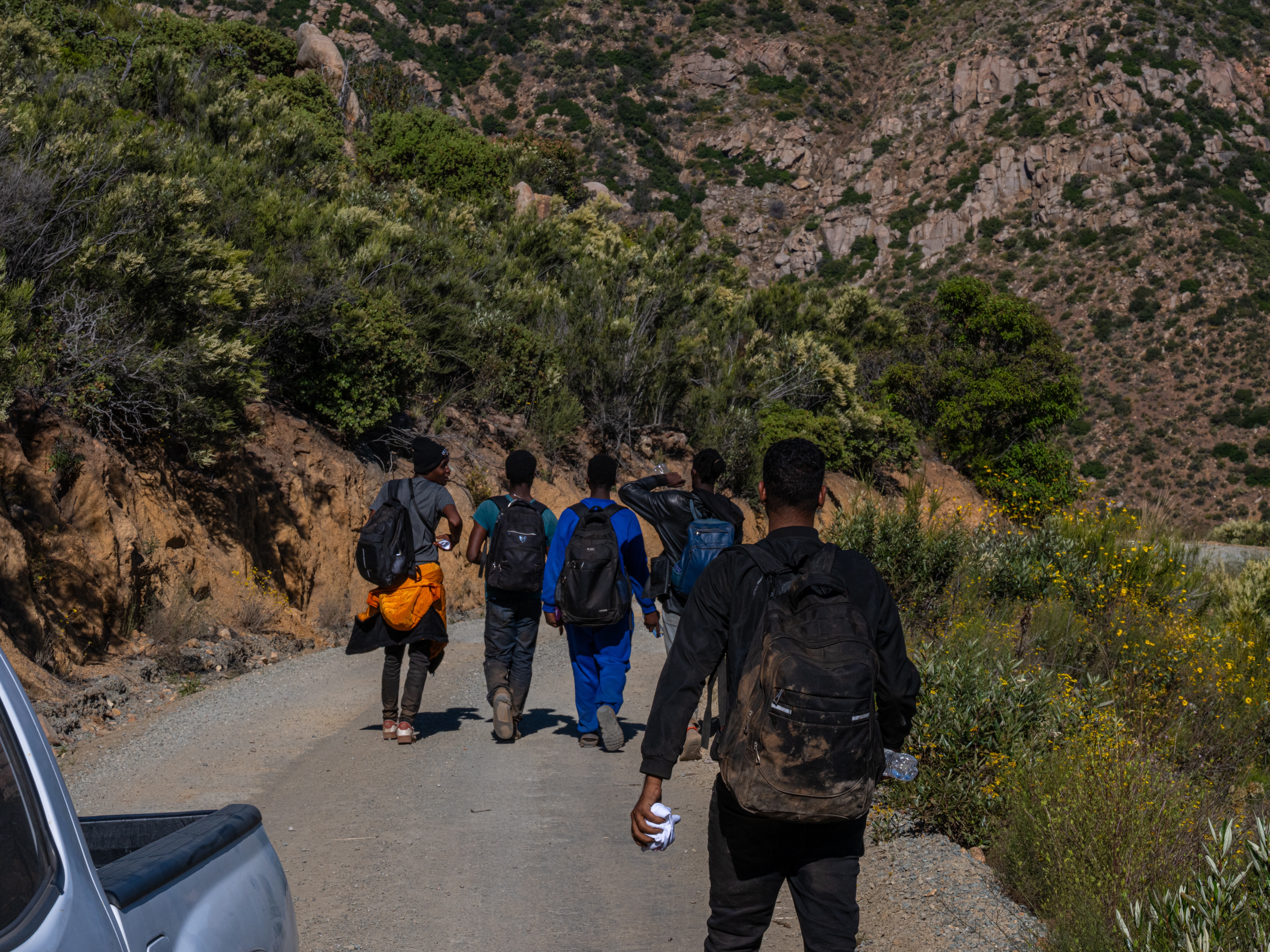 caption: Volunteers with Border Relief Collective provide aid to migrants in the Otay Mountain Wilderness near San Diego, California. Dozens of migrants seeking asylum come through the intensely rugged area each day.