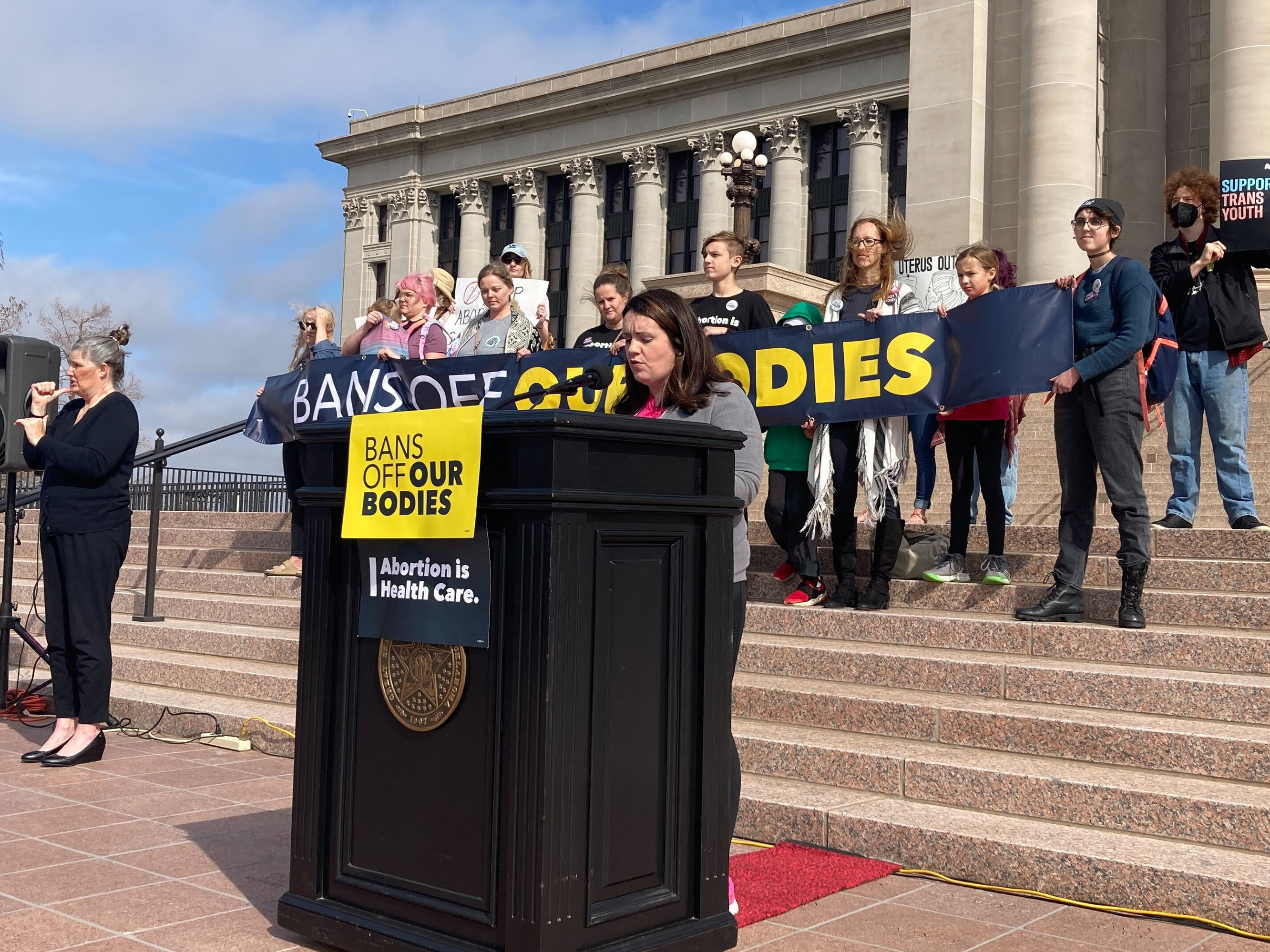 caption: Emily Wales, interim CEO of Planned Parenthood Great Plains Votes, speaks to a group of abortion rights advocates outside the state Capitol in Oklahoma City on Tuesday. The Oklahoma House gave final legislative approval to a bill that would make performing an abortion a felony.