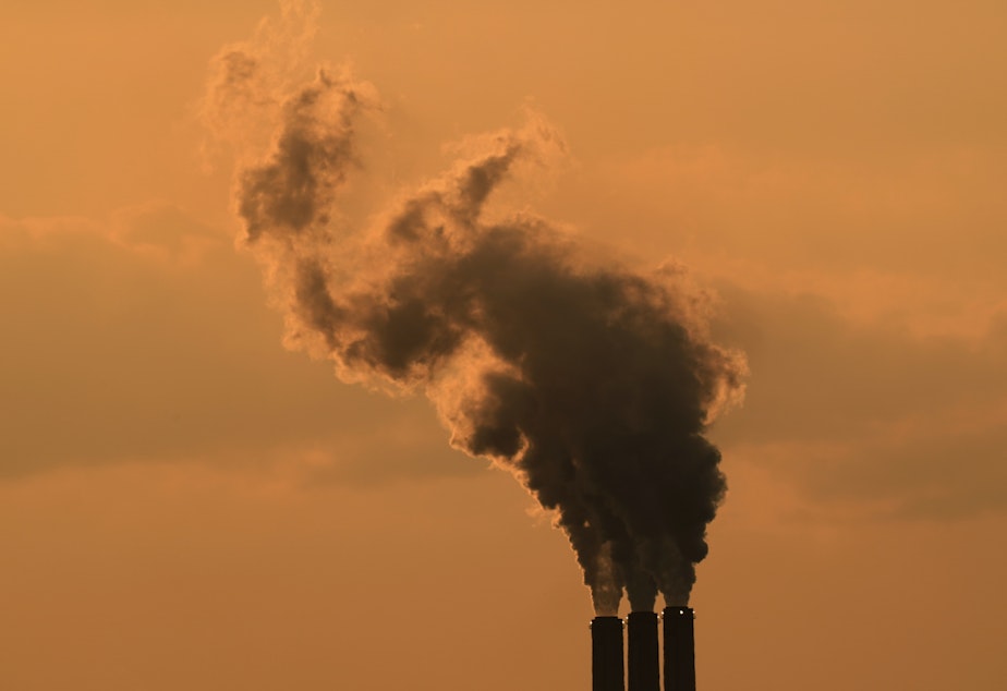 caption: Smokestacks at the Jeffrey Energy Center coal-fired power plant are silhouetted against the sky at sunset in September near Emmet, Kan.