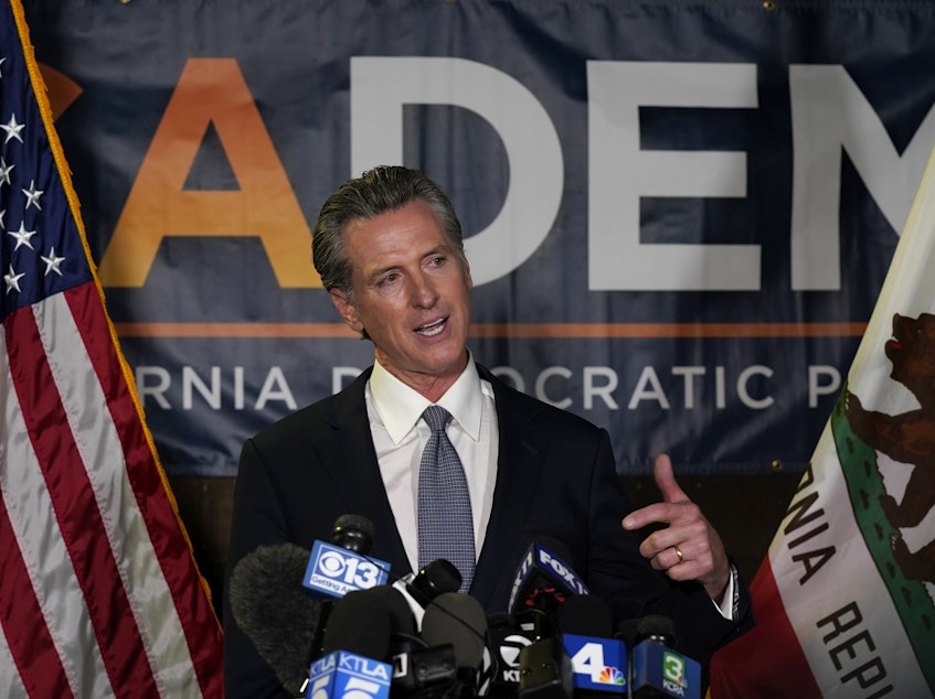 caption: California Gov. Gavin Newsom addresses reporters after beating back the recall that aimed to remove him from office.