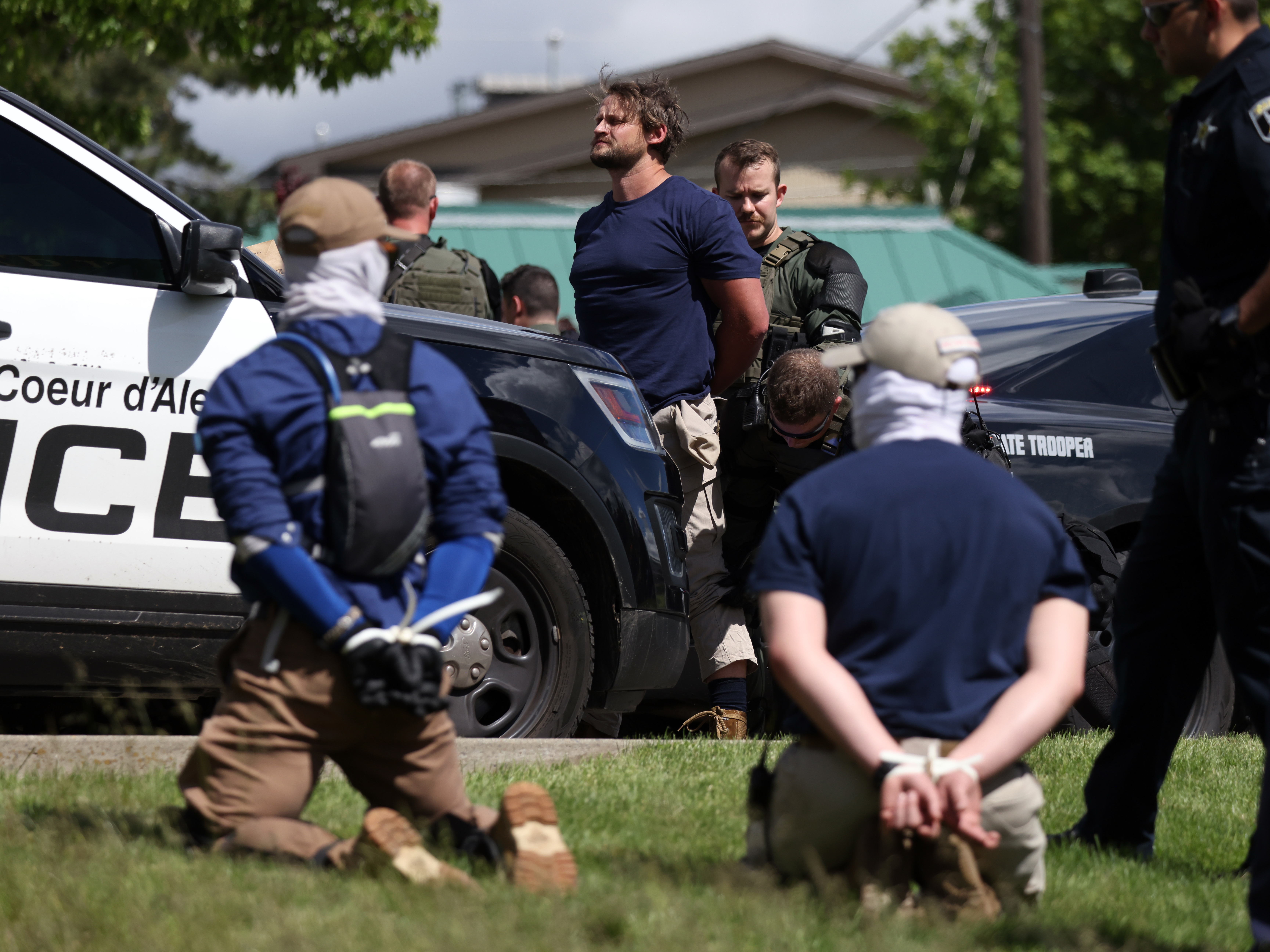 caption: Law enforcement detains and arrest 31 members of the white nationalist group Patriot Front on suspicion of conspiracy to riot after they were removed from a U-Haul truck near the LGBTQ community's Pride in the Park event in Coeur d'Alene, Idaho, June 11, 2022.
