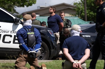 caption: Law enforcement detains and arrest 31 members of the white nationalist group Patriot Front on suspicion of conspiracy to riot after they were removed from a U-Haul truck near the LGBTQ community's Pride in the Park event in Coeur d'Alene, Idaho, June 11, 2022.